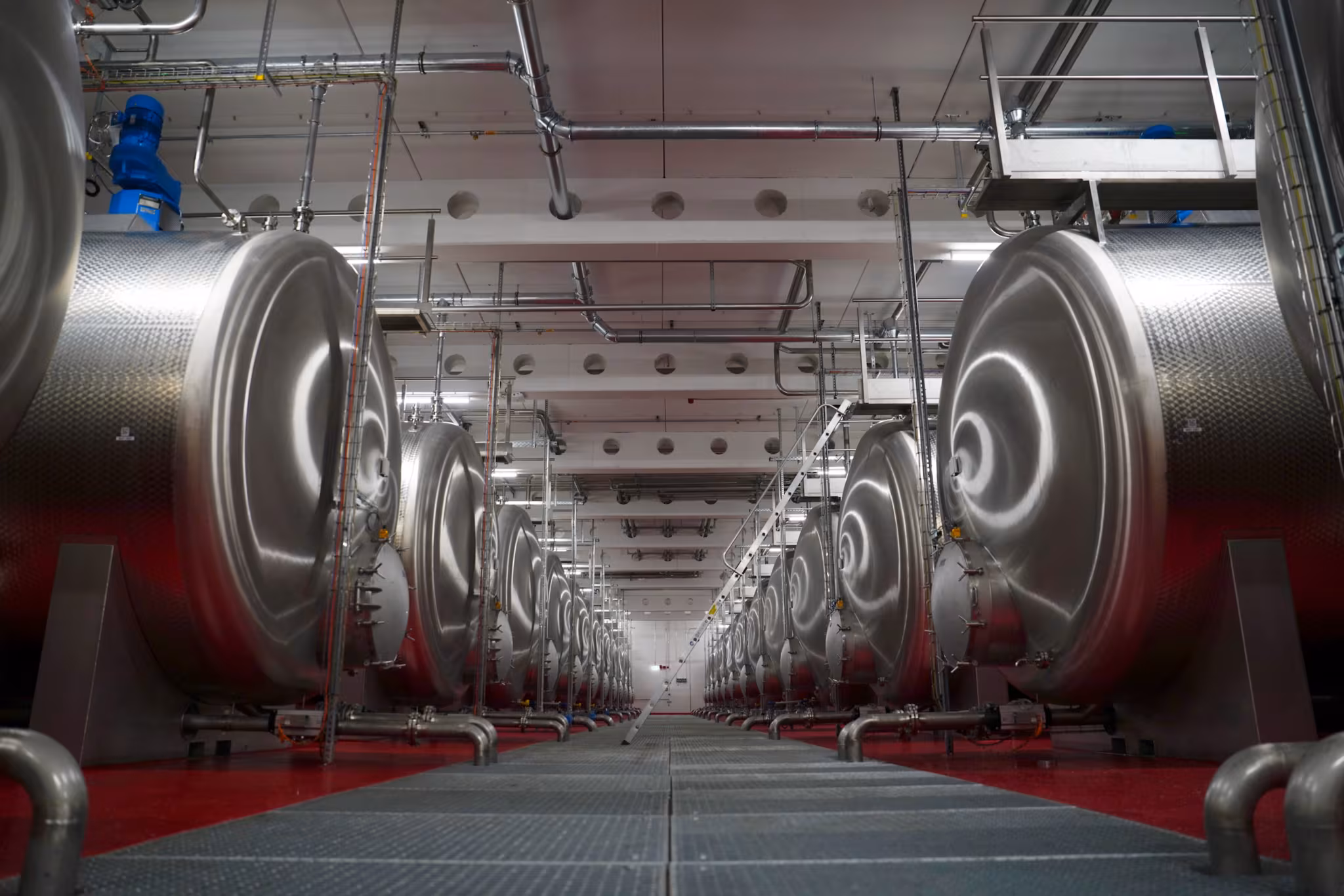 Une série de grandes cuves en acier inoxydable destinées aux matières premières liquides et aux mélanges dans la nouvelle usine de production Sonax