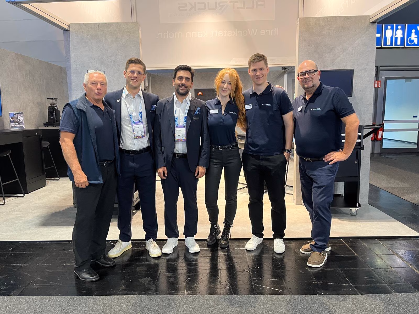 Seis personas del equipo de Alltrucks y de SuperPanther están una al lado de otra en el stand de Alltrucks de la IAA Transportation 2026